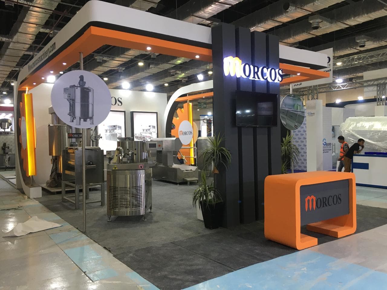 Orange-and-black gear motif signage, Equal's stand for Morcos Machinery