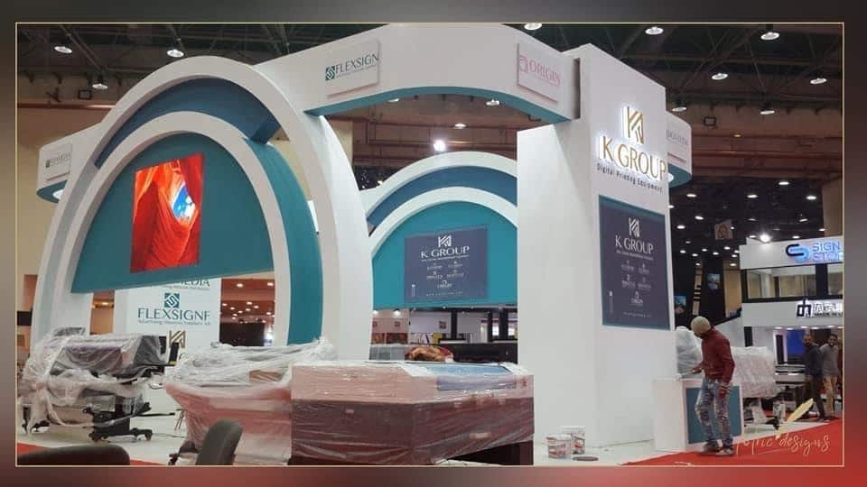 Triple-arch teal portal structure, Equal's stand for K Group